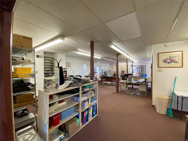 basement featuring a paneled ceiling