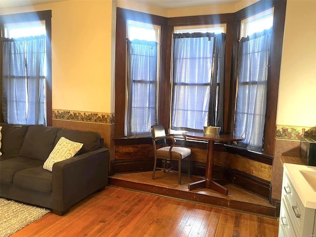 sitting room with wood-type flooring