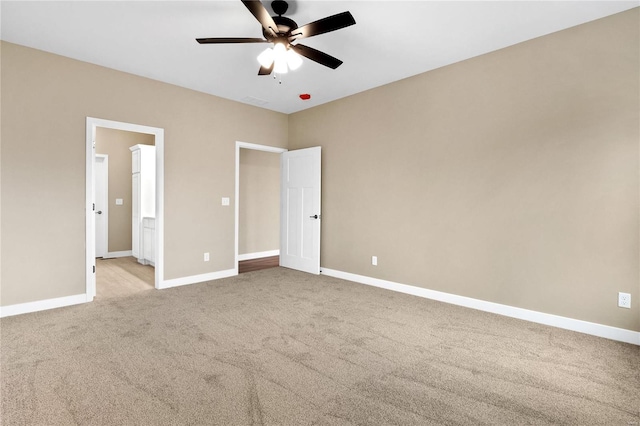 unfurnished bedroom with ceiling fan and light colored carpet