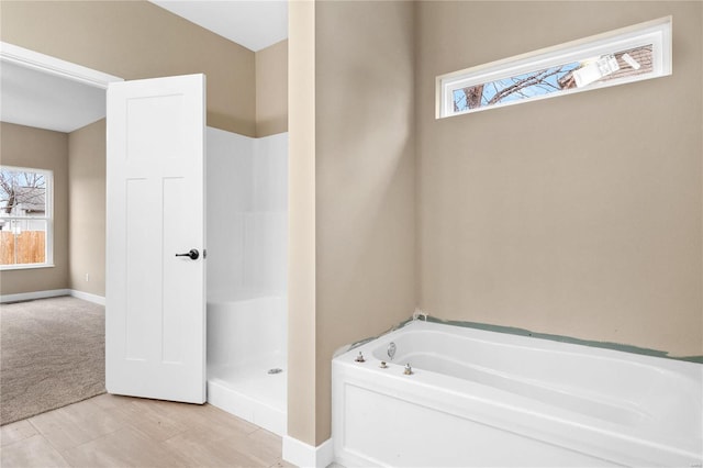 bathroom featuring hardwood / wood-style floors and separate shower and tub