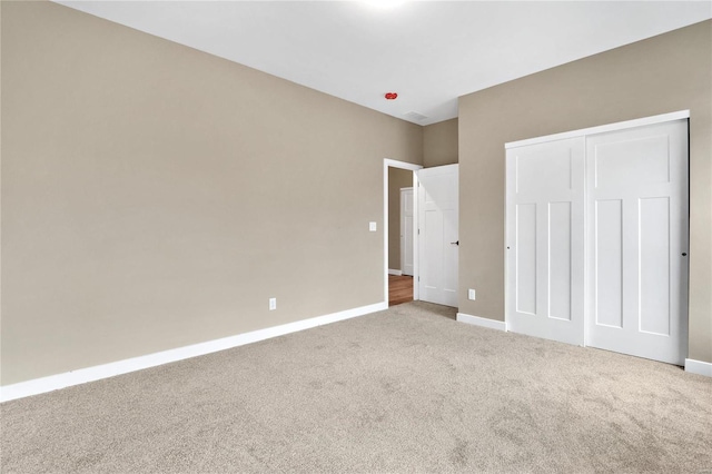 unfurnished bedroom featuring a closet and carpet floors