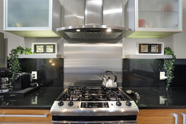 kitchen with island exhaust hood, backsplash, and stainless steel range with gas stovetop