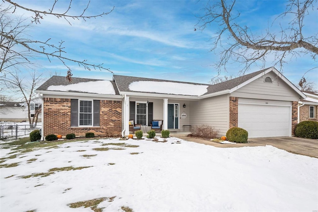 ranch-style home with a garage and a porch