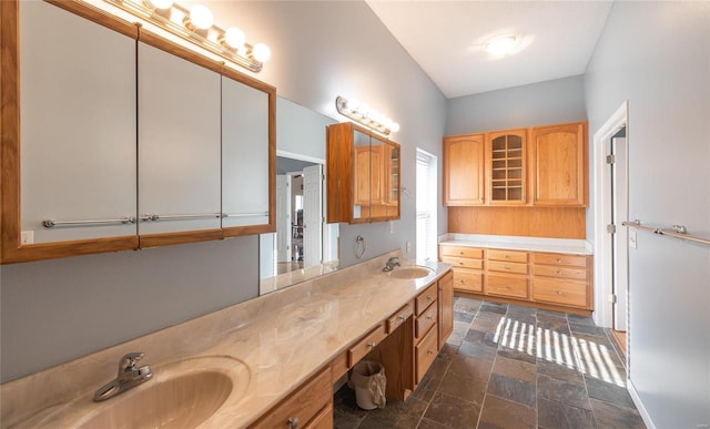 bathroom with vanity and a bath