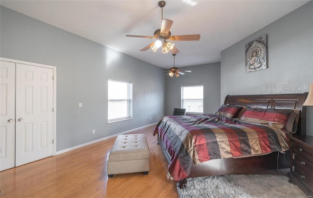 bedroom featuring light wood-type flooring, a closet, and ceiling fan