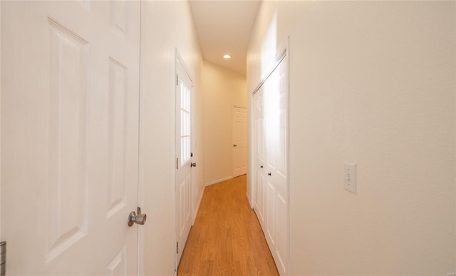 corridor with light hardwood / wood-style flooring