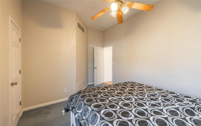 bedroom with ceiling fan and dark colored carpet