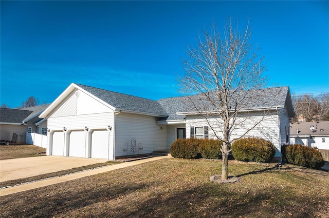 ranch-style house featuring a garage and a front yard