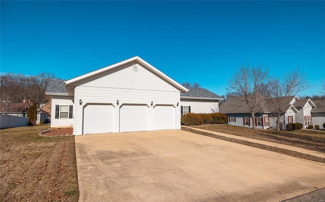 view of front of house with a garage and a front lawn