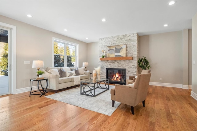 living room with a fireplace and light hardwood / wood-style flooring