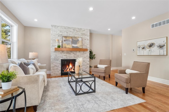 living room with a fireplace and light hardwood / wood-style floors