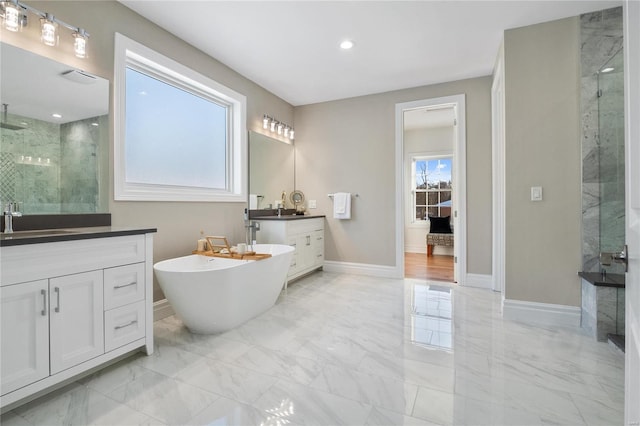 bathroom with vanity, separate shower and tub, and a healthy amount of sunlight