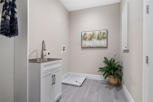 laundry room featuring hookup for a washing machine, sink, cabinets, and electric dryer hookup