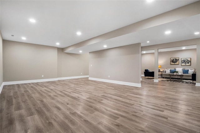 basement with light hardwood / wood-style flooring