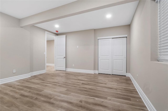 unfurnished bedroom featuring a closet and light hardwood / wood-style floors