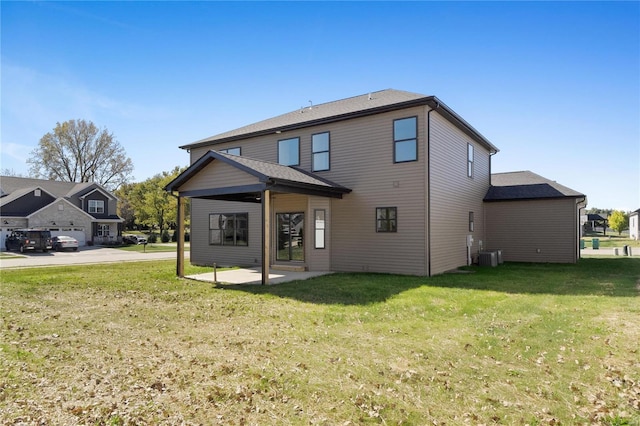 rear view of house with central air condition unit, a yard, and a patio