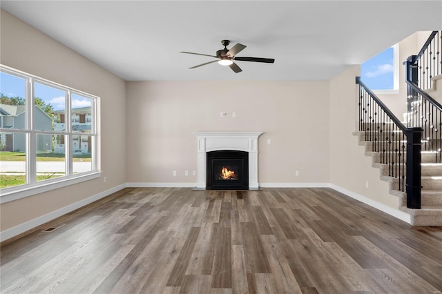 unfurnished living room with ceiling fan and hardwood / wood-style flooring