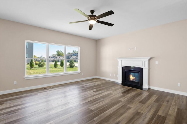 unfurnished living room featuring ceiling fan and hardwood / wood-style floors