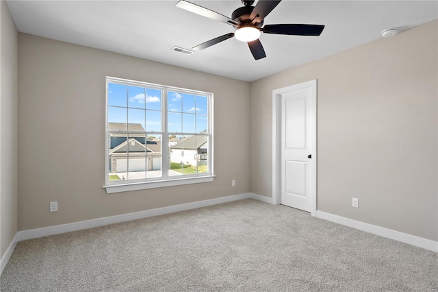 unfurnished room featuring light carpet and ceiling fan