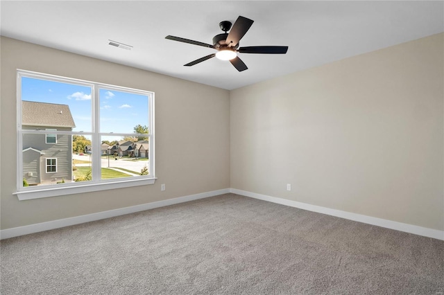 carpeted spare room with ceiling fan