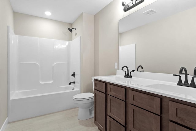 full bathroom with toilet, vanity, and shower / bathtub combination