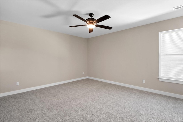 carpeted spare room featuring ceiling fan