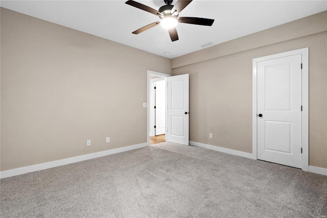 unfurnished bedroom featuring ceiling fan and light carpet