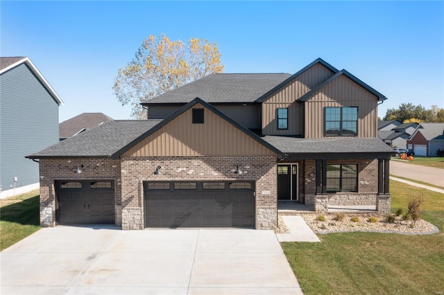 view of front of house featuring a garage and a front lawn