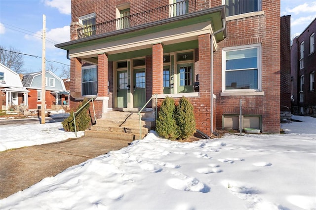 view of snow covered property entrance