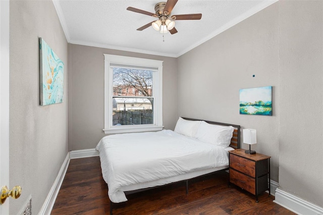 bedroom with ceiling fan, a textured ceiling, dark hardwood / wood-style floors, and crown molding