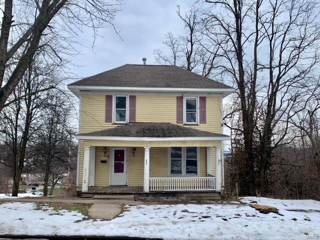 view of property featuring covered porch