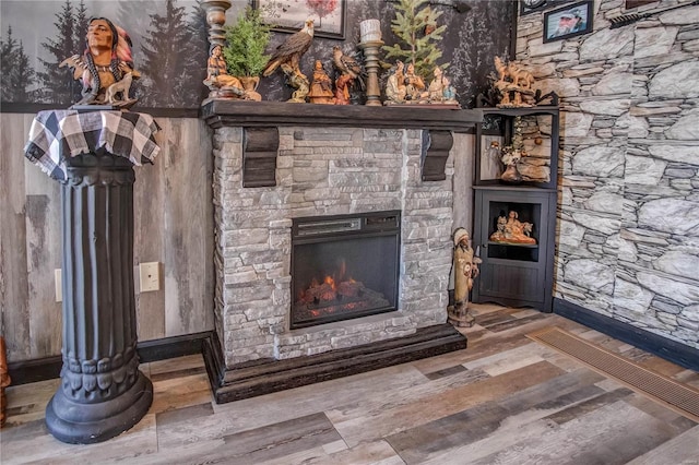 interior details featuring a fireplace and hardwood / wood-style flooring