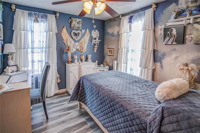 bedroom featuring ceiling fan and light hardwood / wood-style floors