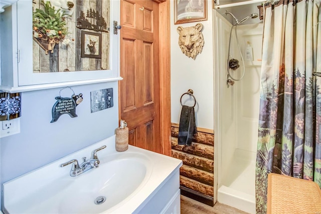 bathroom featuring vanity and curtained shower