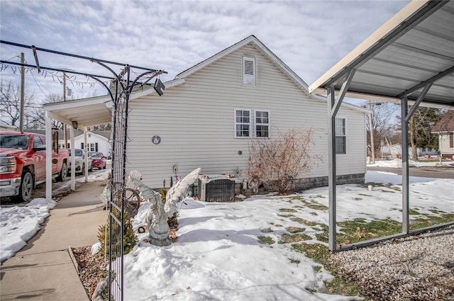 snow covered property featuring central air condition unit