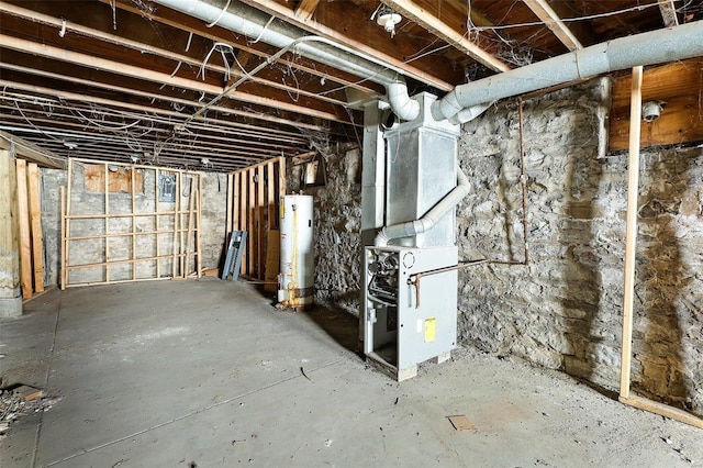 unfinished below grade area featuring water heater and heating unit