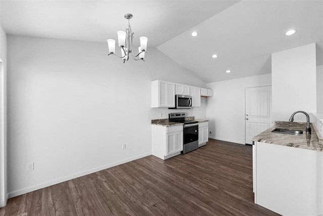 kitchen featuring stainless steel appliances, white cabinetry, hanging light fixtures, and sink