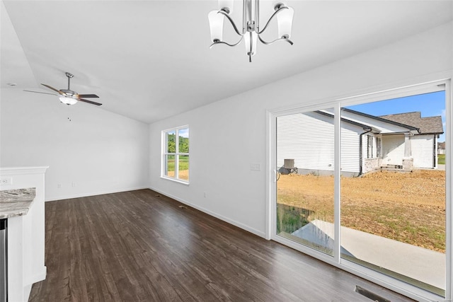 unfurnished living room with vaulted ceiling, dark hardwood / wood-style floors, and ceiling fan with notable chandelier