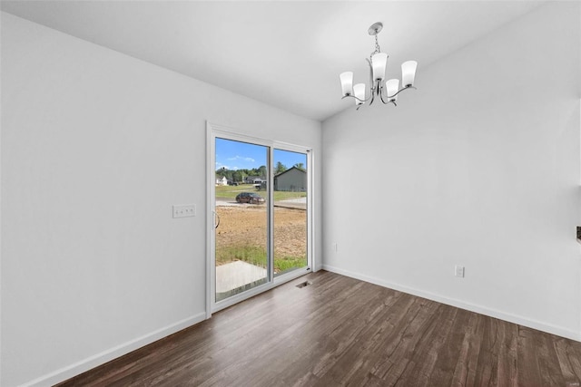 unfurnished room featuring vaulted ceiling, an inviting chandelier, a wealth of natural light, and dark hardwood / wood-style flooring