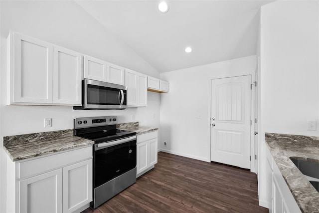 kitchen with stainless steel appliances, dark hardwood / wood-style flooring, white cabinetry, and light stone counters