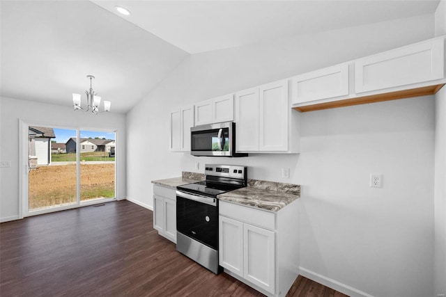 kitchen with dark hardwood / wood-style floors, stainless steel appliances, white cabinets, and hanging light fixtures