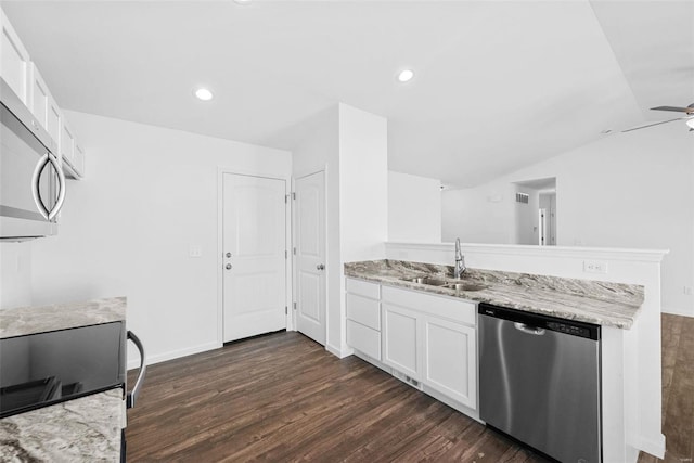 kitchen with vaulted ceiling, sink, light stone countertops, stainless steel appliances, and white cabinets