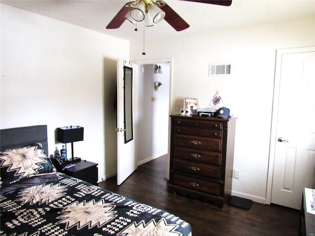 bedroom with dark hardwood / wood-style floors and ceiling fan