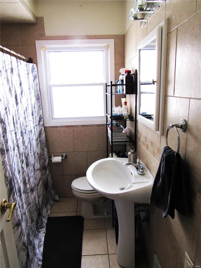 bathroom featuring tile walls, sink, tile patterned floors, and toilet