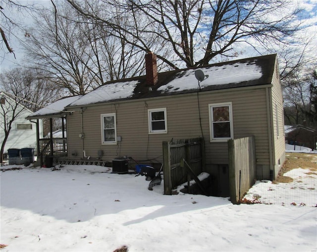 view of snow covered rear of property