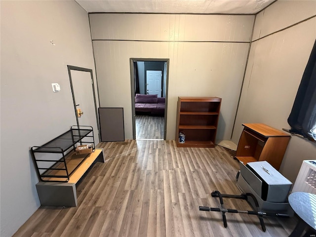 miscellaneous room featuring wood-type flooring and wood walls