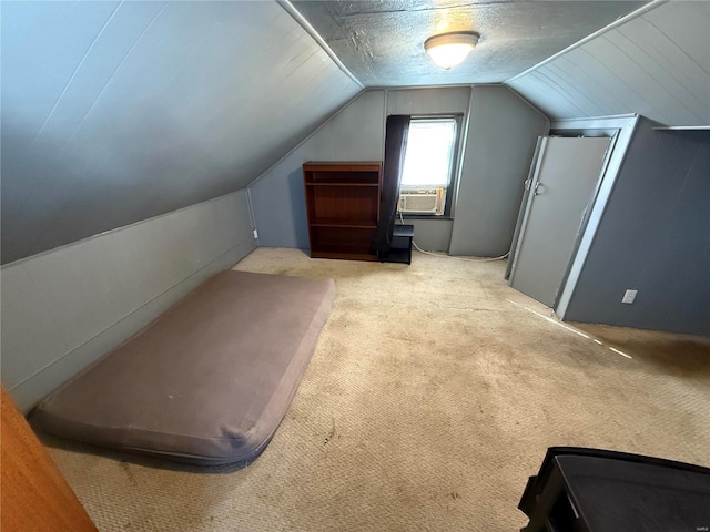 additional living space with lofted ceiling, light colored carpet, cooling unit, and a textured ceiling