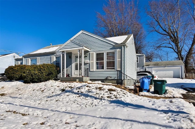 view of front of property featuring a garage and an outdoor structure