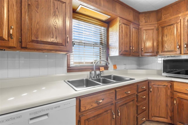 kitchen with dishwasher, backsplash, and sink