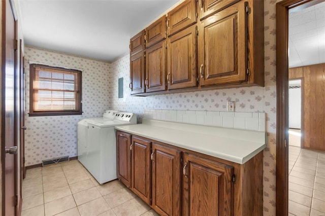 laundry room with light tile patterned floors and cabinets